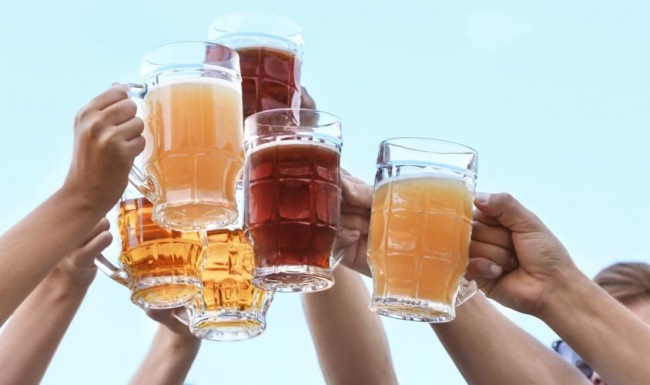 Bustling community with plenty of dining choices a group of people holding glasses of beer