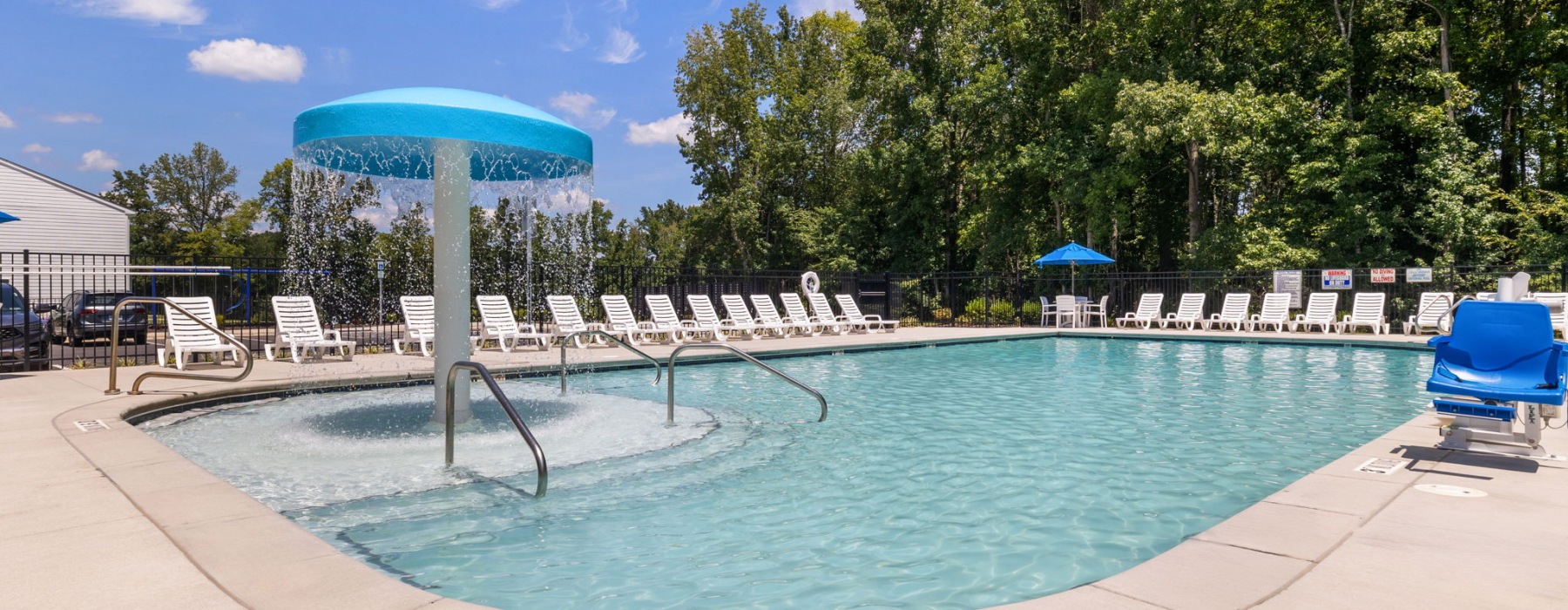 Sparkling pool with lounge chairs and waterfall feature