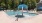 Sparkling pool with lounge chairs and waterfall feature