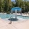 Sparkling pool with lounge chairs and waterfall feature