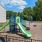 Playground with green features and fence