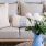 couch with coffee table and a vase with flowers