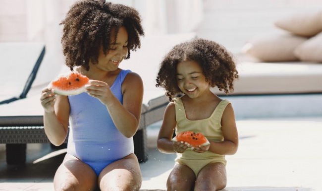 Resort-style swimming pool a couple of kids playing in a pool