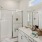 bathroom with sink large mirror and shower