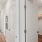 a closet with shelves and a long hallway