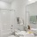 bathroom with large mirror and bathtub