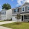 a row of homes with grass and driveways