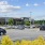 a gorcery store with a large parking lot with trees and cars