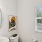 a bathroom with a mirror sink toilet and window