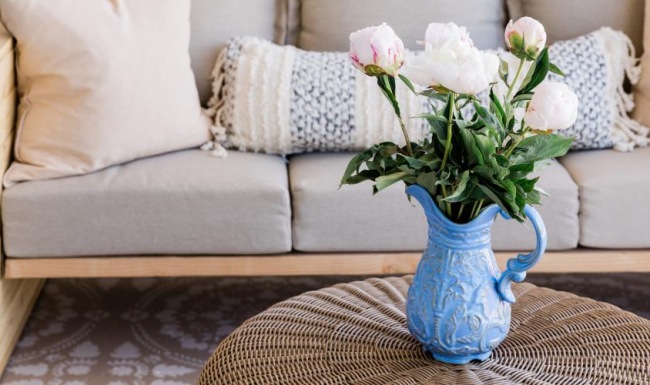 A perfect fit for the whole family a vase of flowers on a couch