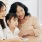 a small family smiling sitting on the couch
