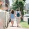 two people walking on a sidewalk